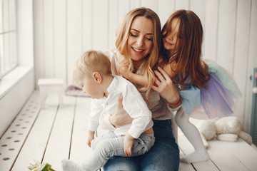 Children give mother flowers. Family at home. Mothers day