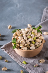 Bowl with pistachios on a rustic background