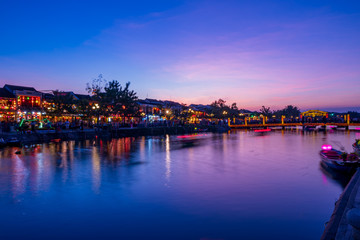 Nightscape at Hoi An old town with passenger boat light trails