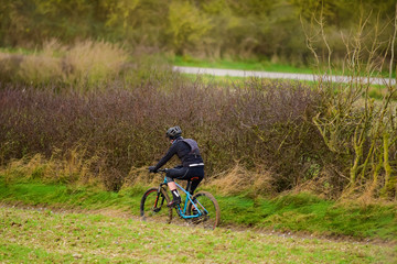 Fototapeta premium mature man mountain biking in country lanes