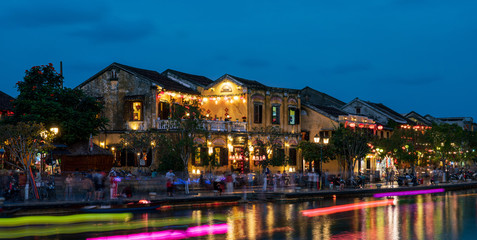 Nightscape at Hoi An old town with passenger boat light trails
