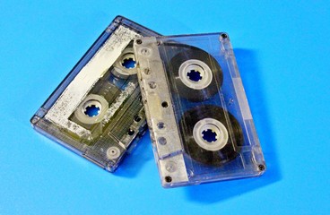 Old audio cassettes located on a blue background