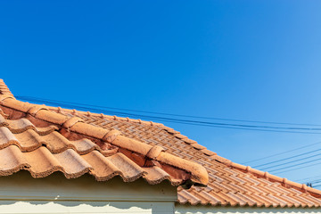 Close up of brown clay roof tiles. Red old dirty roof. Old roof tiles. Construction equipment build a house.