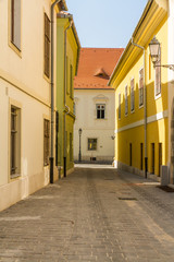 Fototapeta na wymiar Clean old street in bright morning sunshine.