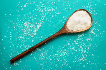 Close up of ground coconut powder on a blue background in a studio at day time