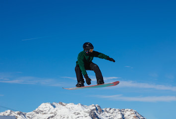 Snowboarder against the blue sky in Livigno, Italy