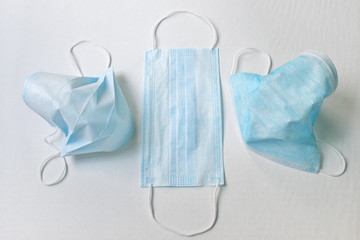Surgical masks in white background showing proper way of wearing face mask. Protection and safety against virus, illness and disease infections