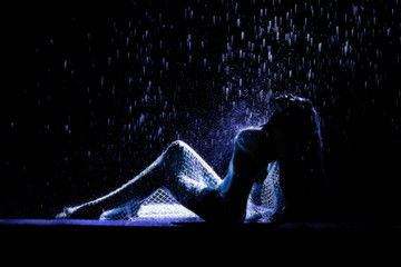 Sexy beautiful woman posing under rain