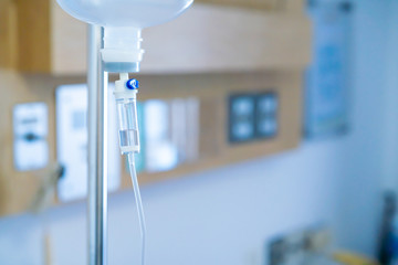 Normal saline bottle hanging from stand in hospital.  Health care and medical concept.
