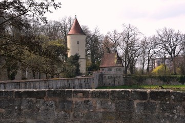 Fototapeta na wymiar Dinkelsbühl (Germany). April 2017. Dinkelsbühl is a medieval city in Germany. The fortress wall of the XIV-XV centuries is fully preserved with towers, gates, bastions.