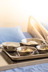 Thai Food Dishes on Tray have Steamed Rice, Green Curry with Chicken.  Stir Fried Cauliflower with Pork and Guava. Breakfast Meal for Patient.