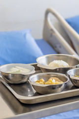 Thai Food Dishes on Tray have Steamed Rice, Green Curry with Chicken.  Stir Fried Cauliflower with Pork and Guava. Breakfast Meal for Patient.