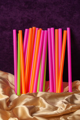 multicolored cocktail tubes on a dark background