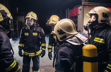 Fototapeta premium Group of firefighters in the fire department checking their gas mask equipment