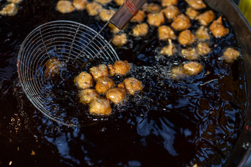 Frying herb spicy meat ball, the traditional local Thai street food.