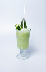 Mango smoothie in a tall glass. Drink in summer on a white background.