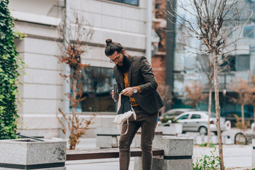 Fashion hipster guy looking in bag