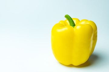 Close up view of ripe yellow bell pepper on white background with copy space
