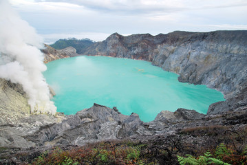Kawah Ijen volcano and sulfur lake is composite volcanoes in the Banyuwangi Regency of East Java, Indonesia, Kawah ijen have Blue fire crater and Sulfur mining. Blue Nature Travel Background