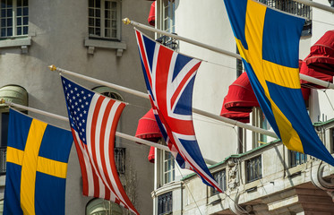 Flags of Great Britain, USA and Sweden on the facade of the hotel