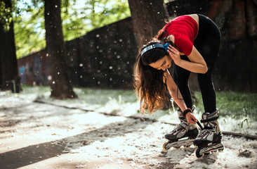 Urban girl listening music and roller skating