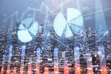 Forex chart on cityscape with skyscrapers wallpaper double exposure. Financial research concept.