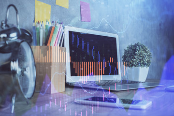 Financial market graph hologram and personal computer on background. Double exposure. Concept of forex.