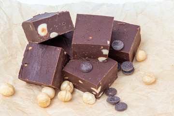 Fudge on a white plate with nuts and chocolate diced