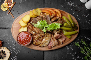 Grilled meat assortment with vegetables and potatoes