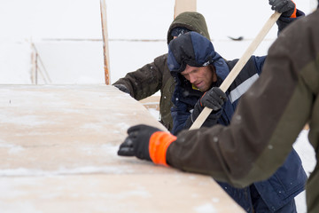 Two workers in overalls at a construction site