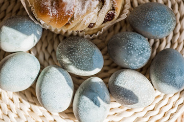Fototapeta na wymiar Easter cake and colored pastel eggs on the rattan napkin background. Beautiful light blue eggs. Easter background. Happy Easter concept. Thrush eggs.