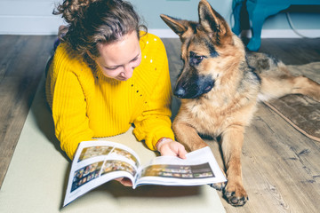 Vintage, retro photo of relaxing woman with her German shepherd