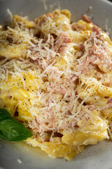 Italian pasta with cream, ham and cheese