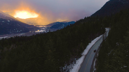 DRONE: Tourists on fun road trip drive up the Sea to Sky Highway at sunrise