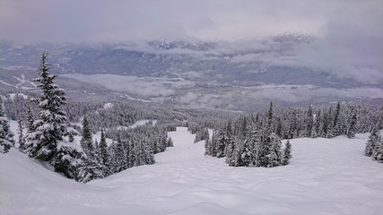 Panoramic view of snowy valley and mountains in remote part of British Columbia.