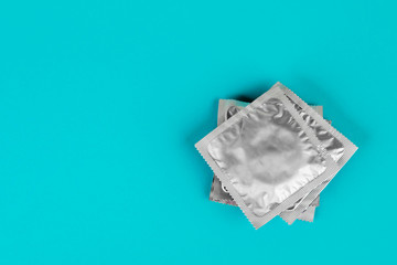 Condom on a blue background. The concept of safe sex.