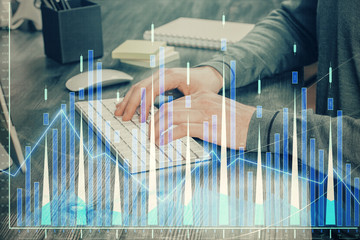 Multi exposure of financial graph with man works in office on background. Concept of analysis.