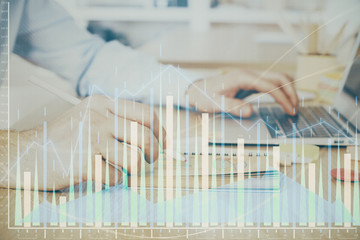 Multi exposure of financial graph with man works in office on background. Concept of analysis.