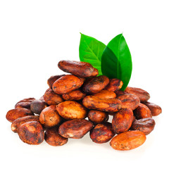 Heap of cacao beans with green leaves isolated on a white background.