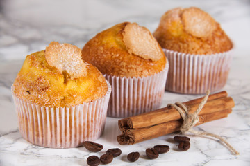 three delicious cupcakes on marble background