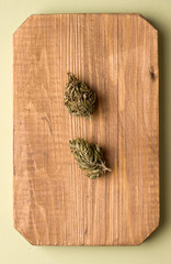 marijuana on a wooden plank. Vertical photo