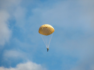 parachutist descends from heaven on a round dome looking down