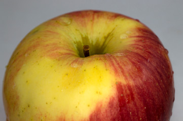 Close-up of red and yellow apple on a blur background, as a representation of healthy life and good health. Space for text.