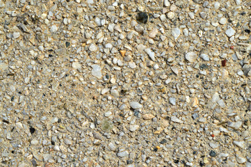Texture of a wall covered with tiny colored and black pebbles that create an excellent background or texture for graphic projects.