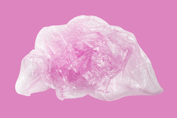 Fototapeta premium Used old pink plastic bag on a pink background. Environmental pollution from the use of plastic. Recycling of plastic waste into pellets as a business.