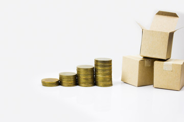 The growth of online business trading and online shopping concept. A rise stacked of coins and Parcel box on white background. Transportation growth.