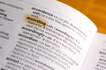 Fototapeta premium The word or phrase According in a dictionary.