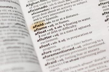 The word or phrase Afield in a dictionary.