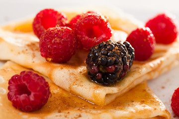 pancakes with raspberries, blackberries and honey