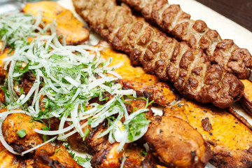 Spiced meat with herbs and onions, fried in tandoor. Shish kebab. Barbecue.
